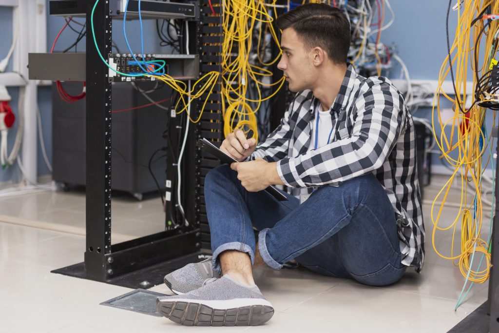 handsome-engineer-working-server-room